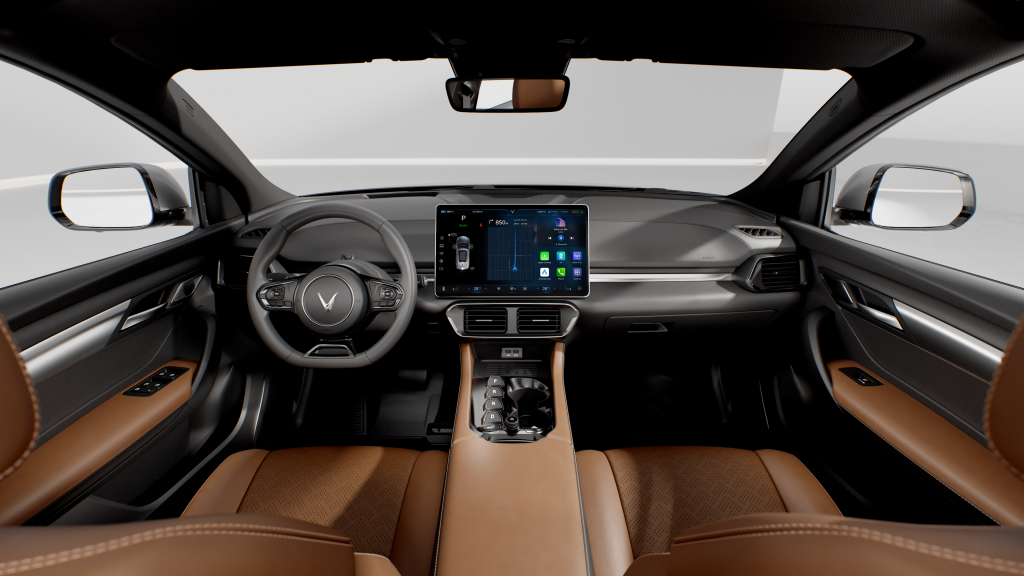 Interior view of a luxury car cabin with tan leather seats, steering wheel, and a central touchscreen display